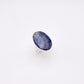 A silver ring featuring an oval-shaped cabochon sodalite gemstone with natural blue and white cloudy patterns, set against a plain white background.