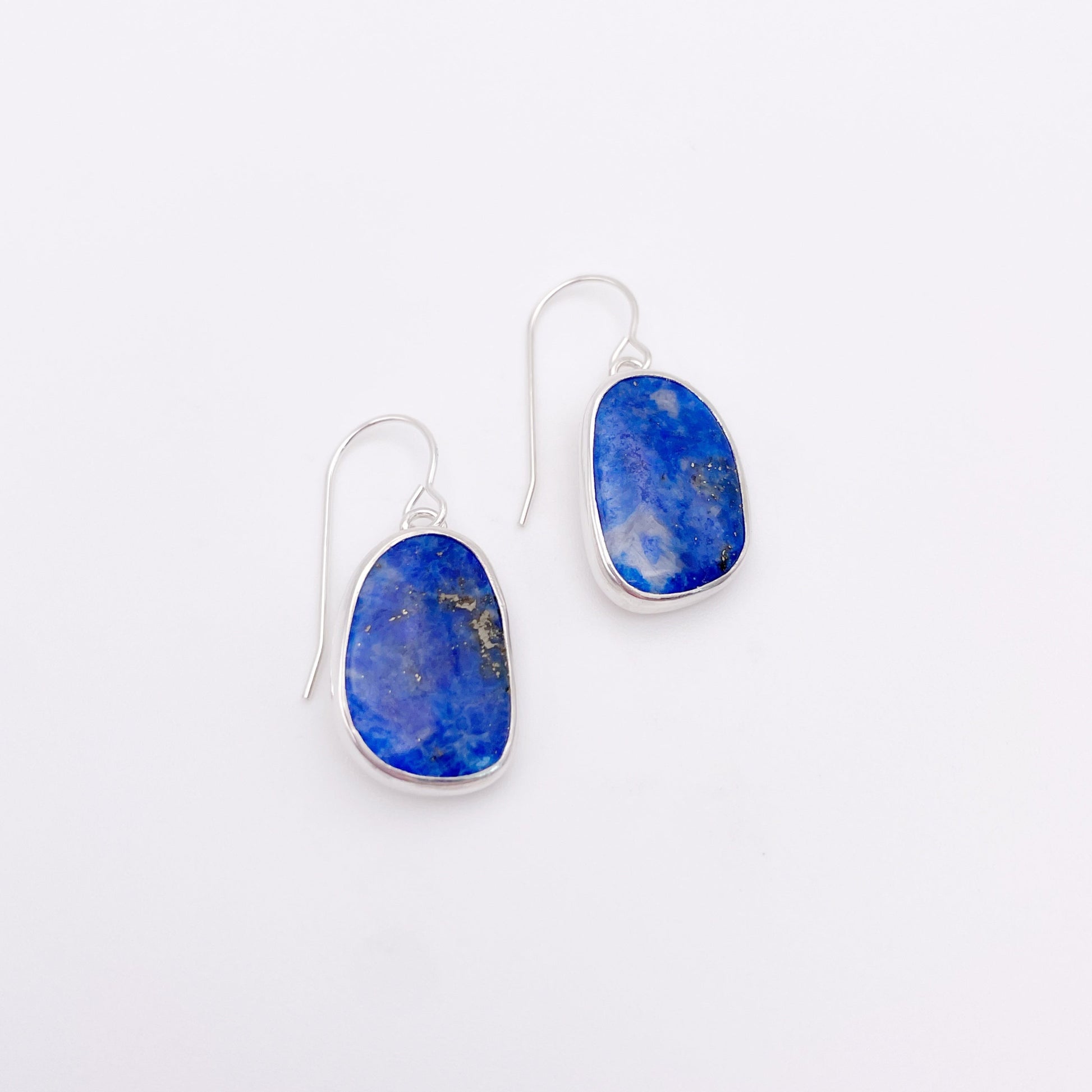 Pair of earrings with blue stones on a white background